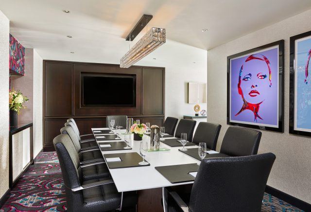art fills the walls in this modern and technology equipped boardroom