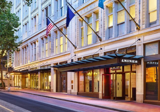 exterior of the nines hotel at dusk