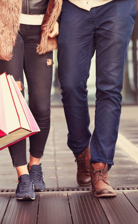 a couple shopping in the city with shopping bags with fall wardrobe